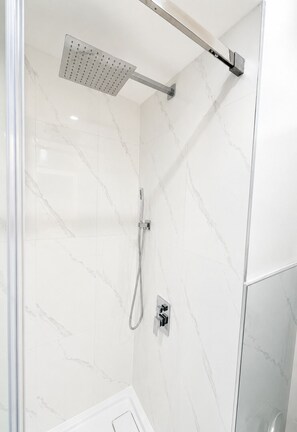 A shower with a handheld showerhead and a wall-mounted control panel. - Park View 3BR Home.Covered SunDeck. Near Metrotown (Vancouver)