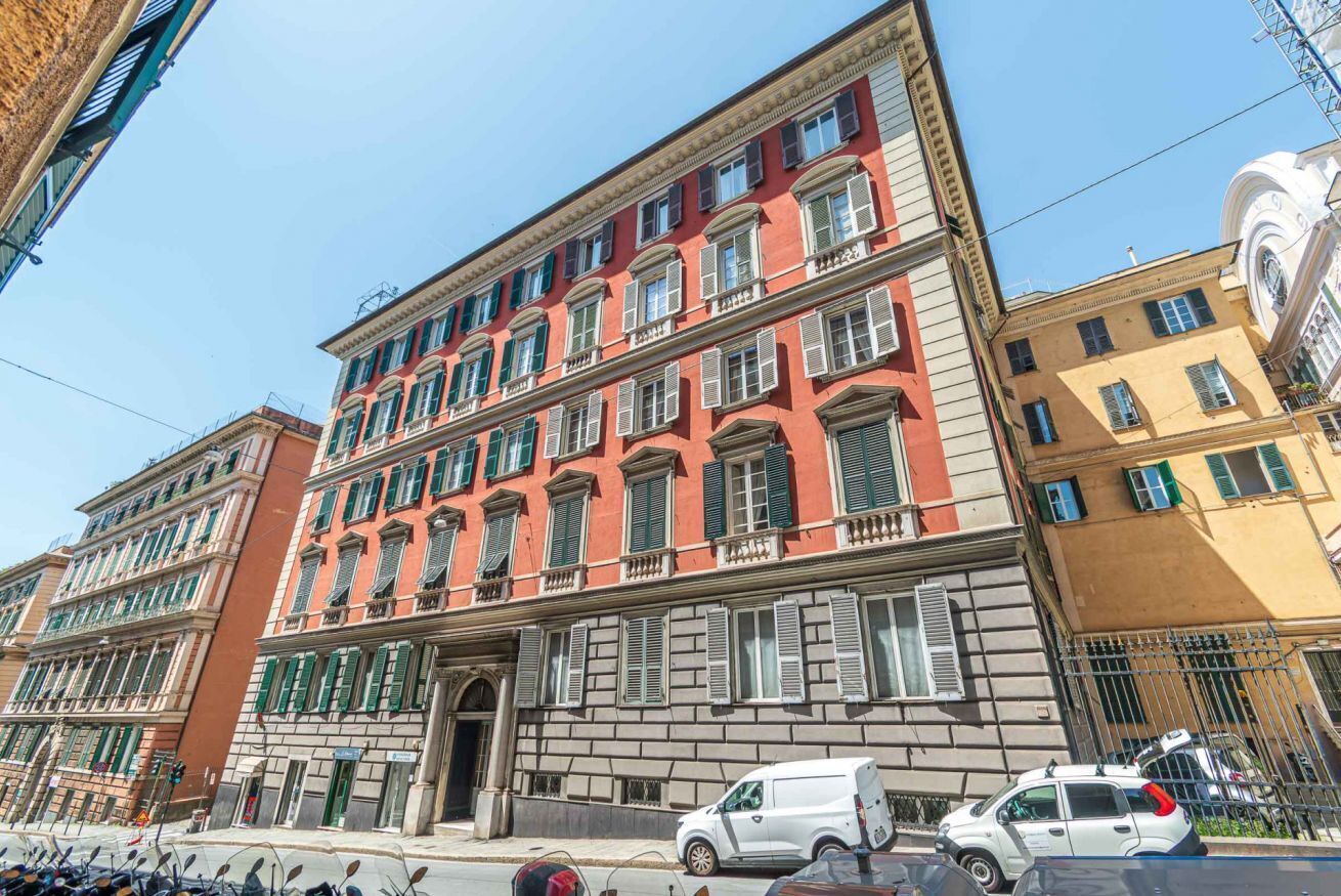 A multi-story building with a classic architectural style, featuring a prominent entrance with a decorative archway.