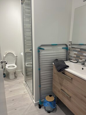 Ein Badezimmer mit Toilette, Dusche und Waschbecken.