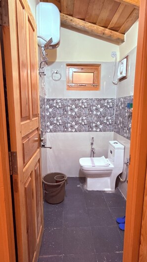 A bathroom with a toilet, bidet, and shower. - The Peach Hillside Kainchi Dham (Bhowali Gaon)
