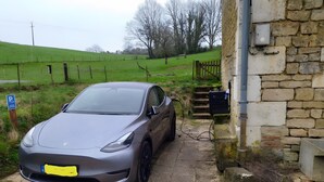 A car parked outside a stone building with a grassy field in the background. - Guest Room 'La Fosse Bleue, Sanglier' with Shared Terrace and Wi-Fi (Signy-l'Abbaye)