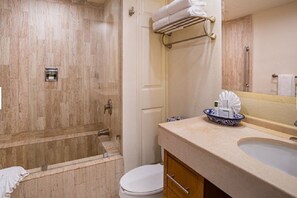 A bathroom with a bathtub, toilet, sink, and towel rack. - Villa del Pal Mar Cabo San Lucas ocean front resort  Studio (Cabo San Lucas)
