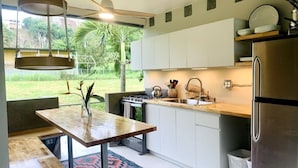 Eine moderne Küche mit Gaskochfeld, Spüle und einem Edelstahl-Kühlschrank.