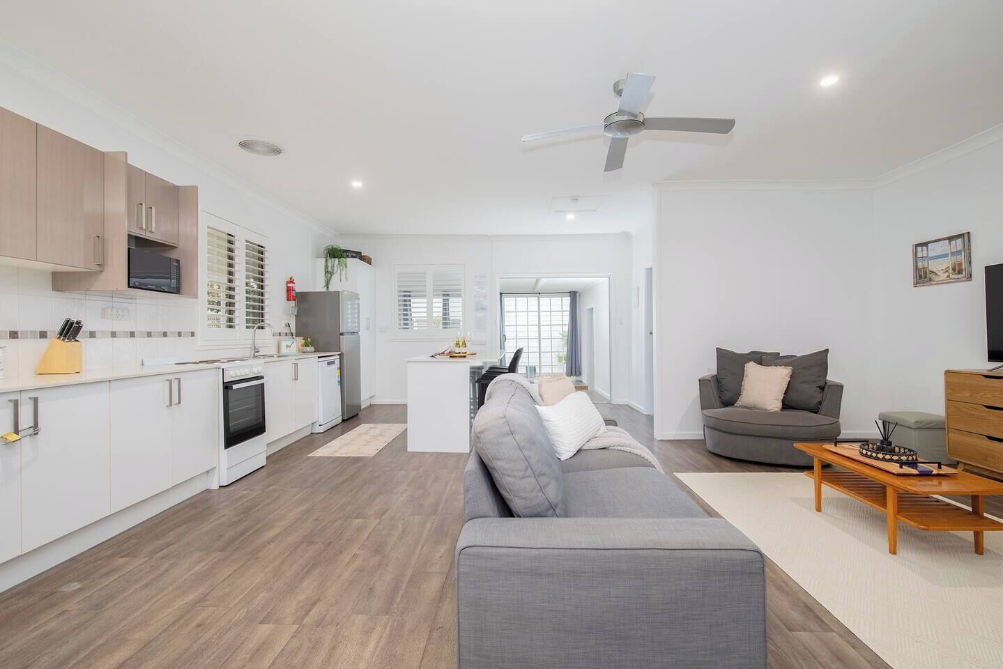 A modern apartment with a kitchen, living area, and a balcony.