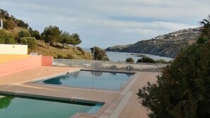 A swimming pool with a view of the sea and hills. - Holiday Home in 'Port Aloès' Resort with Sea View, Shared Pool and Air Conditioning (Cerbère)