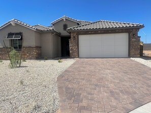 A residential house with a tiled roof, a garage, and a gravel driveway. - Spacious 4 bedroom Retreat with Beautiful Pool in Glendale. Sleeps 10-12 (Glendale)