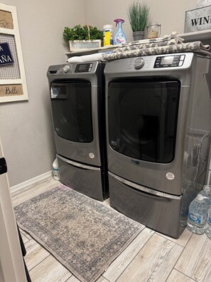 A laundry area with two Maytag dryers, a rug, and a water dispenser. - Spacious 4 bedroom 4 bath Retreat with Beautiful Pool in Glendale. Sleeps 10-12 (Glendale)