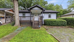 A single-story house with a front porch, a visible garage, and a well-maintained lawn. - 3BR Home Downtown Atlanta | BeltLine | Mozley Park (Atlanta)