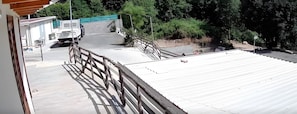 A building with a flat roof, a staircase leading to a higher level, and a parked truck.