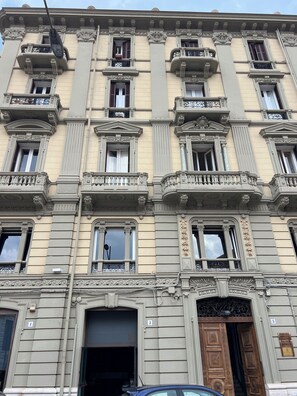 A multi-story building with ornate architectural details, including columns, balconies, and decorative moldings. - Vrbo Property (Bari)