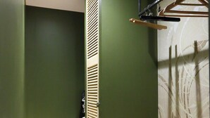 A laundry room with a washing machine, wooden cabinets, and a hanging rack. - ATELIER CHARNOZ, heritage and Parodian ceramics (Paray-le-Monial)