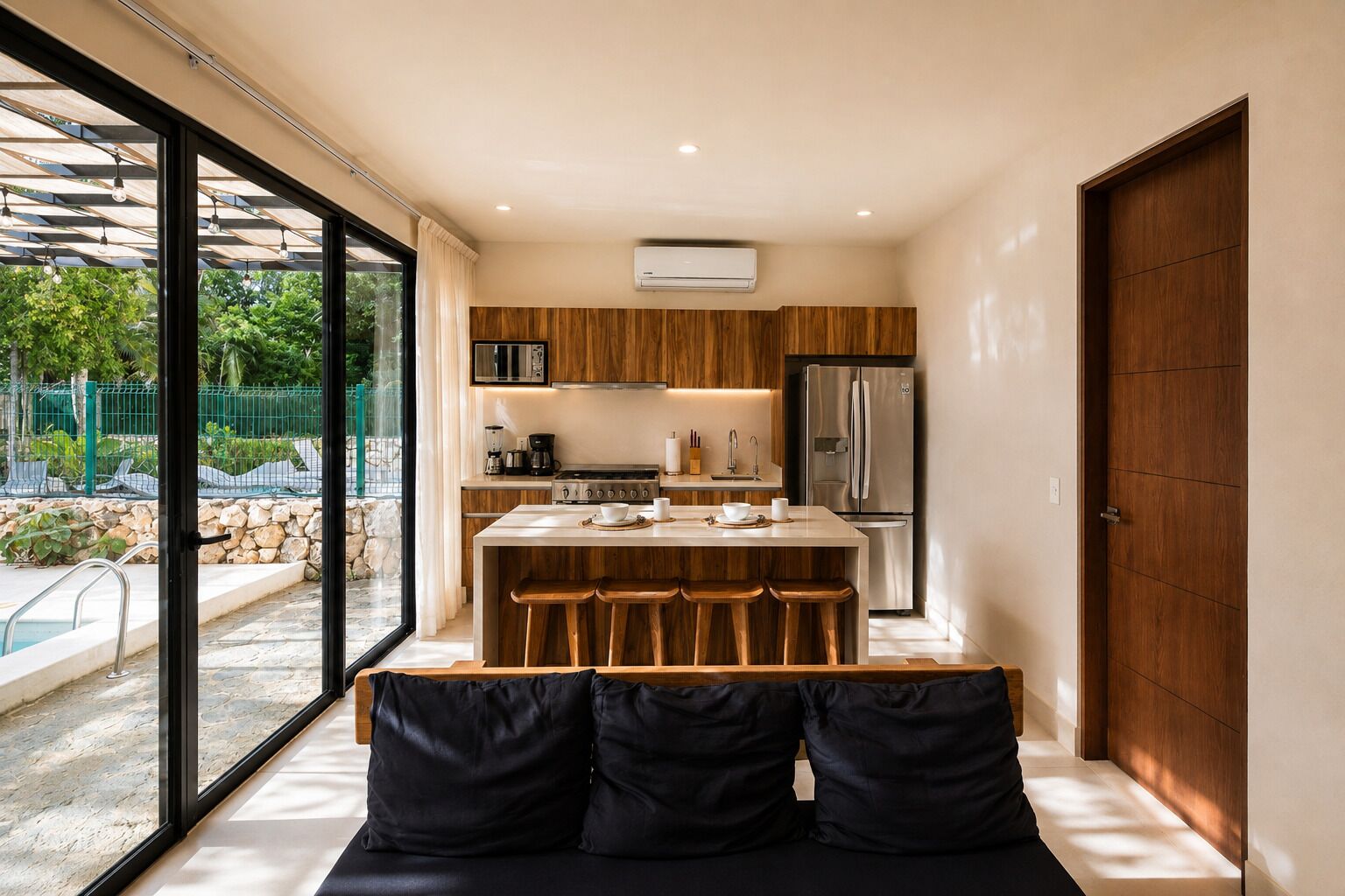 A modern kitchen with a central island, a built-in oven, and a refrigerator.