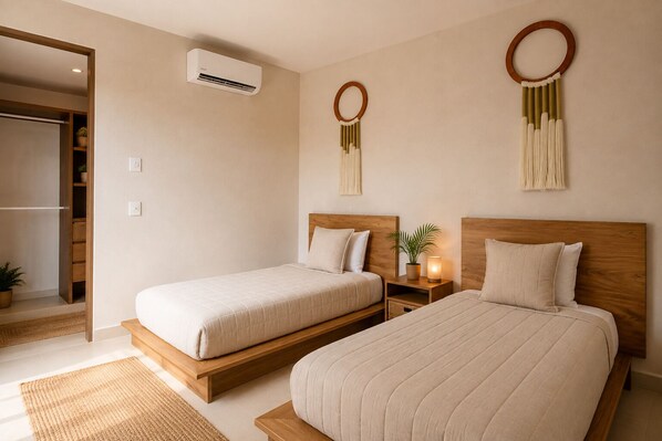 A hotel room with two beds, a wooden headboard, a bedside table with a lamp, a wall-mounted air conditioner, and a small potted plant.