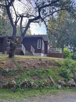 A cabin with a wooden exterior, a front porch, and a staircase leading to a deck. - Suite 3 for the win! Secluded suite overlooking the harbour, Spectacular views (Thetis Island)
