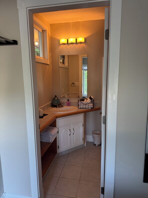 A bathroom with a sink, mirror, towel rack, and a window. - Suite 3 for the win! Secluded suite overlooking the harbour, Spectacular views (Thetis Island)