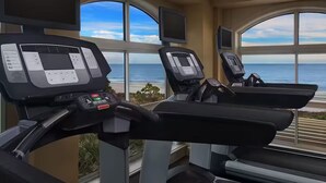 A gym with treadmills, large windows, and a view of the ocean. - Resort with 2 bedrooms and AC in beautiful Marriott Grande Ocean (Hilton Head Island)