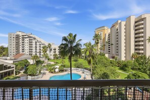 A hotel with a pool surrounded by palm trees and a view of other buildings. - Orlando Family Resort - 2 Miles to Universal! (Orlando)