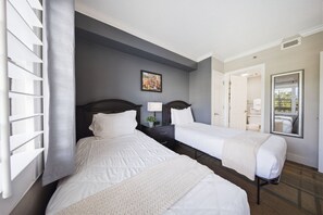 A hotel room with two beds, a nightstand, a lamp, a framed picture on the wall, and a mirror. - Orlando Family Resort - 2 Miles to Universal! (Orlando)