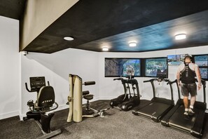 A gym with treadmills, an elliptical, and a stationary bike. - Spacious Ocean View Condo w/Resort Amenities 1108 (Miami Beach)