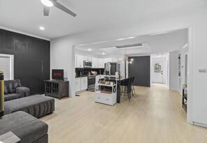 A modern living space with a kitchen, dining area, and seating area. - Spacious Home - Near Duke Hospital, Downtown Durham & RTP (Durham)