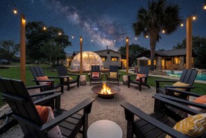 An outdoor seating area with chairs and a fire pit, under a night sky with visible stars. - Private Golf Course Epic Fun - Birdie Creek Estate (Driftwood)