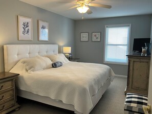 A bedroom with a bed, a nightstand, a lamp, a ceiling fan, a window with blinds, and a dresser. - Spacious 3 Bedroom 2 Full baths in Wildwood Crest. 3 Blocks from to the beach. (Wildwood)