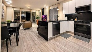 A modern kitchen with a central island, built-in oven, and microwave. - 4BR Private Pool Home with Lake View Near Disney | Sleeps 10 (Clermont)