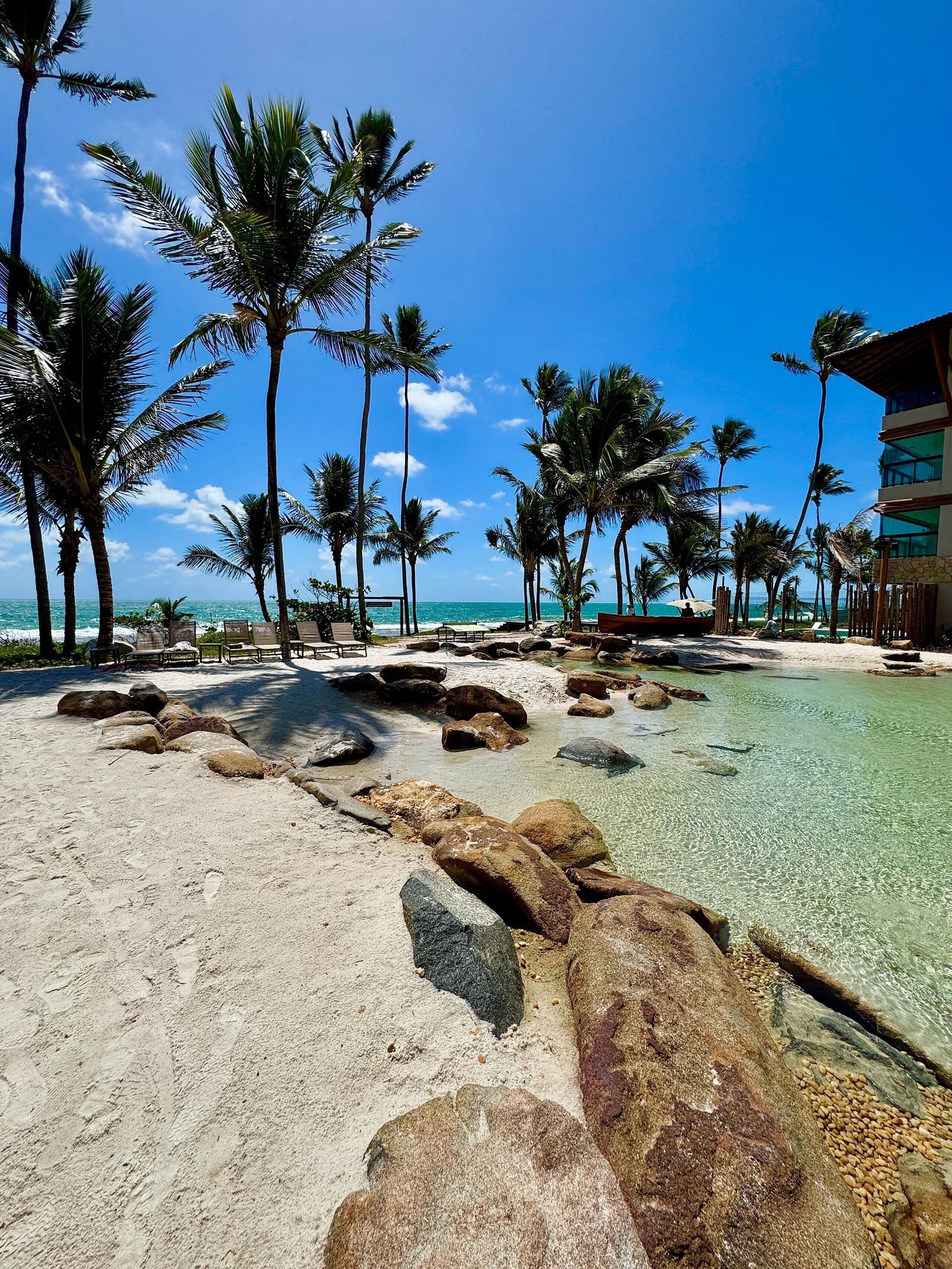 On the beach, white sand, sun-loungers, beach umbrellas