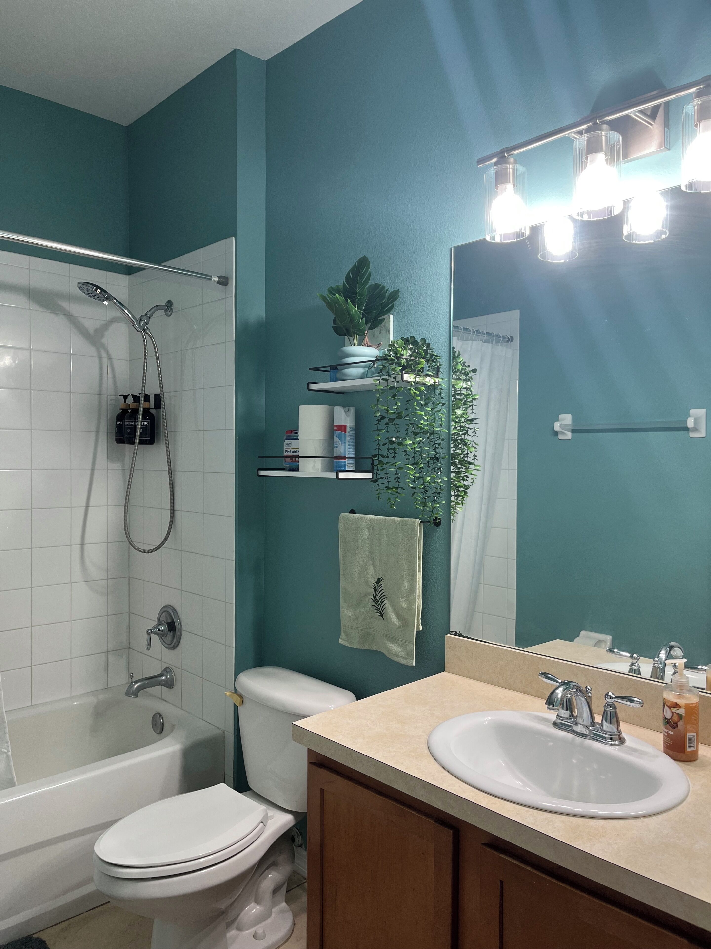 Ein Badezimmer mit Badewanne, Toilette, Waschbecken und Spiegel.