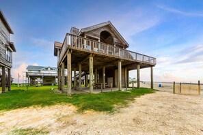 A wooden structure with a balcony, a covered porch, and a beach view. - Beach Front - The Hamptons at Spanish Grant (Galveston)