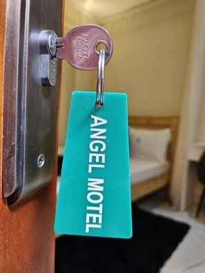 A key with a tag labeled 'ANGEL MOTEL' attached to a door lock. - angel motel ntinda (Kampala)