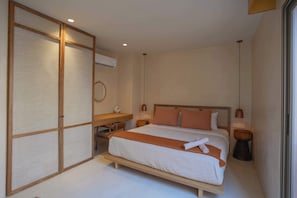 A bedroom with a bed, bedside tables, a desk, and a large sliding door. - 1BR Penthouse in Aflora condo w/ Private Pool (Tulum)