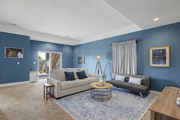A living room with two sofas, a coffee table, and a rug.