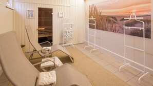 A room with two reclining chairs, a towel, a wall-mounted towel rack, and a beach-themed painting. - Delmaro, vacation home 6 pers., near beach. (Middelkerke)