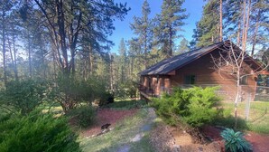 A cabin surrounded by a forest with a clear path leading to it. - Gorgeous house for rent during Sturgis Rally 2026 (Rapid City)