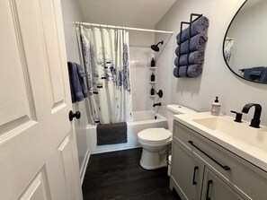 A bathroom with a bathtub, toilet, and sink. - ShnowFun: Ski-In/Ski-Out & Summer Adventure Condo (Great Valley)
