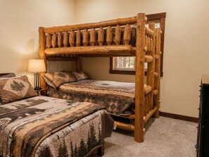 A bunk bed with a wooden frame and a window above it. - Cozy Newly Remodeled 2BR Downstairs Suite - TV & Grill Access (Hamburg)