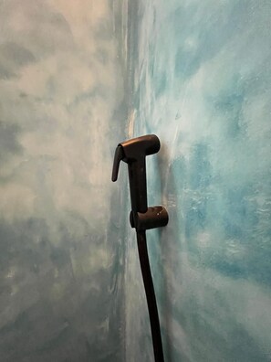 A hammer leaning against a wall with a textured surface. - Azure Chameleon House. (Jambiani)