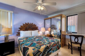 A bedroom with a bed, a desk, a chair, a ceiling fan, and a window. - Charming Golf-view Condo With Pool, Hot Tub, Terrace & Wifi (San José del Cabo)