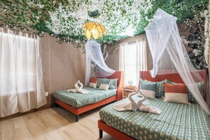 Ein Zimmer mit zwei Betten, jeweils mit Baldachin, und einer dekorativen Decke.
