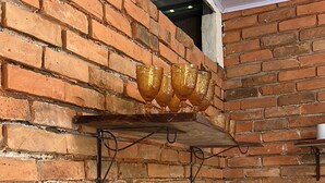 A kitchen with a brick wall, a stainless steel sink, and a marble countertop. - Delightful 1-bedroom fully equipped cabin in Nuevo Colón welcomes your stay! (Nuevo Colón)