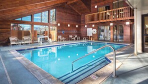 An indoor swimming pool with wooden walls, clear windows, and a balcony overlooking the pool. - Relaxing 3 bedroom resort in amazing Steamboat Springs with amenities! (Steamboat Springs)