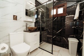 A bathroom with a toilet, sink, and glass shower enclosure. - SerenityOne - Centrally located Apt,SO19 (Agia Napa)