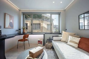 A modern bedroom with a large window, a bed, a desk, and a chair. - Cozy Spacious Studio Psyri AcropolisView (Athina)