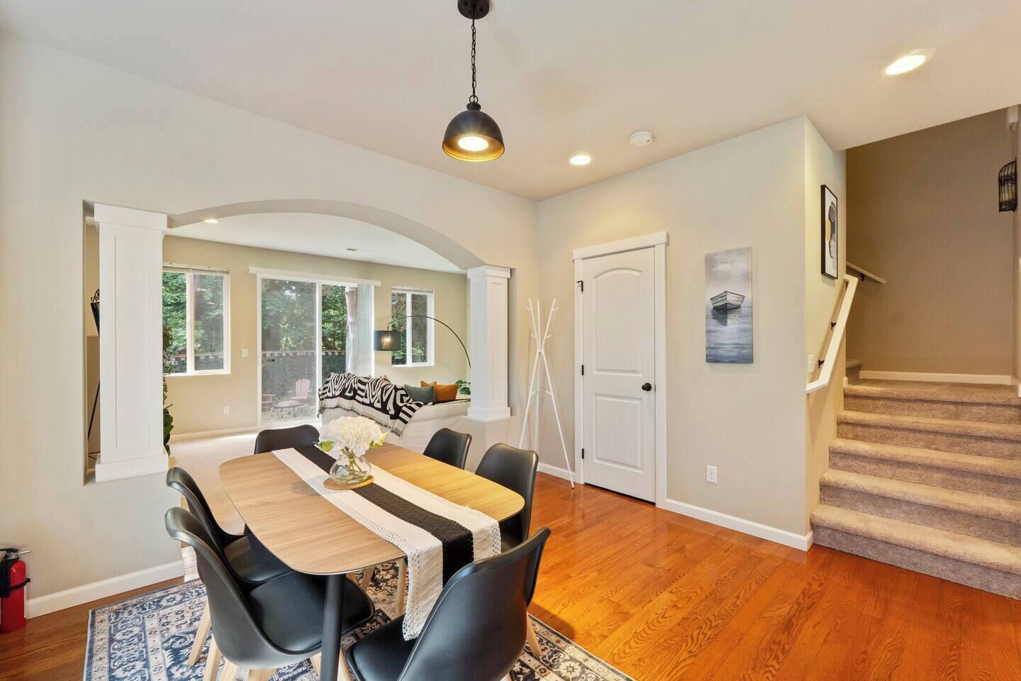 A dining area with a table, chairs, and a view of the outdoors.