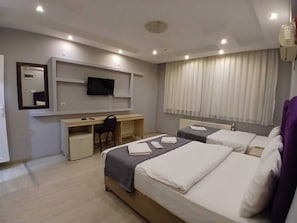 A hotel room with two beds, a desk, a chair, a television, and a window with curtains. - PERA CITY OTEL (Samsun)