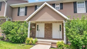 A two-story house with a front porch, two doors, and a brick facade. - Cozy Bloomington Townhouse Close to IU Campus (Bloomington)