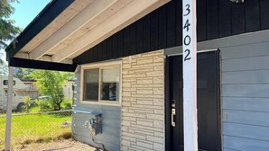 A building with a number '3402' on the wall, a door, and a window.