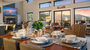 A dining area with a view of mountains, a fireplace, and a television. - Sugar Maple Summit a Luxury Cabin w/ Breathtaking Views in Shagbark (Sevierville)