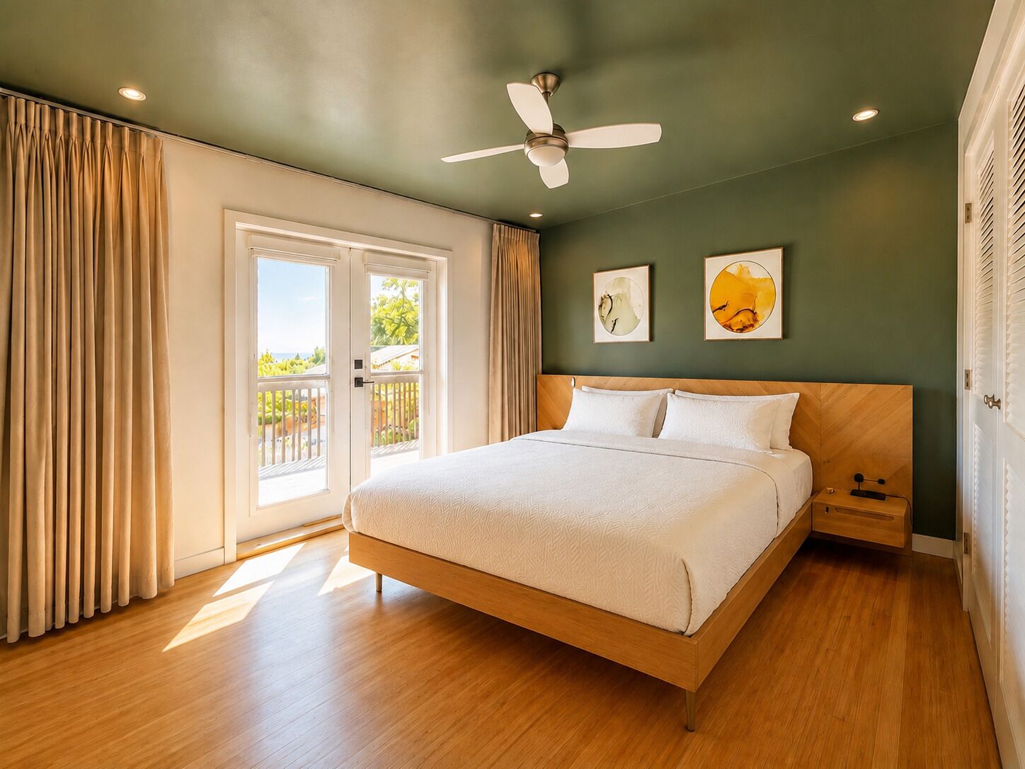 A bedroom with a bed, ceiling fan, artwork, and a view through the window.. Family-Friendly 3BR Suite with Mount Baker & Bay Views